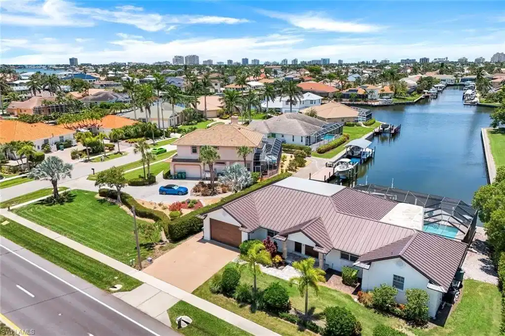 Image 1: Aerial perspective of suburban area with skyline and a large body of water