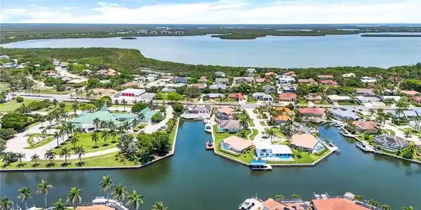 Image 2: Aerial view of residential area with a large body of water