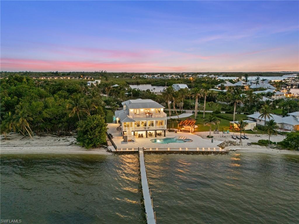 Image 1: 5150 sq ft interior with an additional 2,900 bonus first level finished space along with 227 feet of Charlotte Harbour frontage with your own private beach. This stunning home provides the perfect boating lifestyle!
