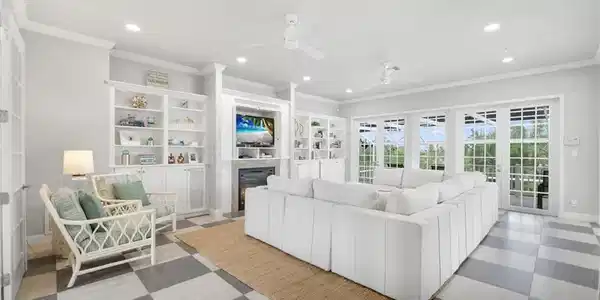Image 4: Living room with ornamental molding, recessed lighting, ceiling fan, a glass covered fireplace, and light flooring