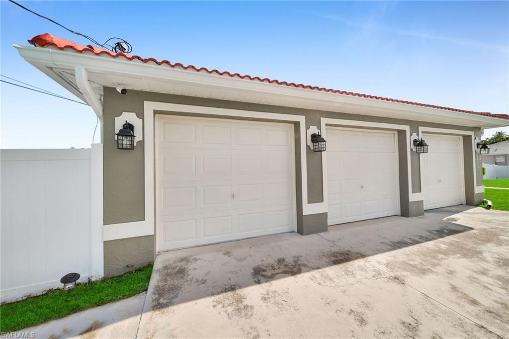 Image 1: Mediterranean / spanish-style home featuring stucco siding, concrete driveway, a garage, and a tiled roof