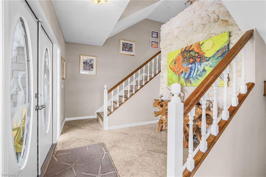 Image 3: Foyer entrance featuring baseboards and stairway
