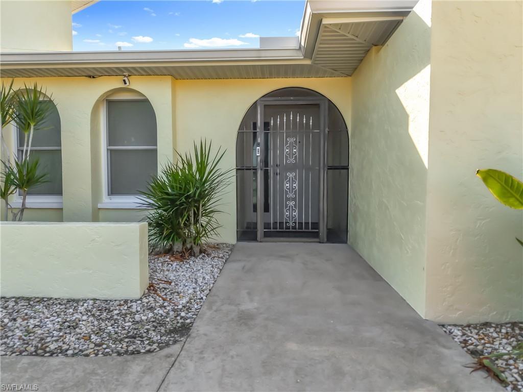 Image 4: View of exterior entry featuring stucco siding