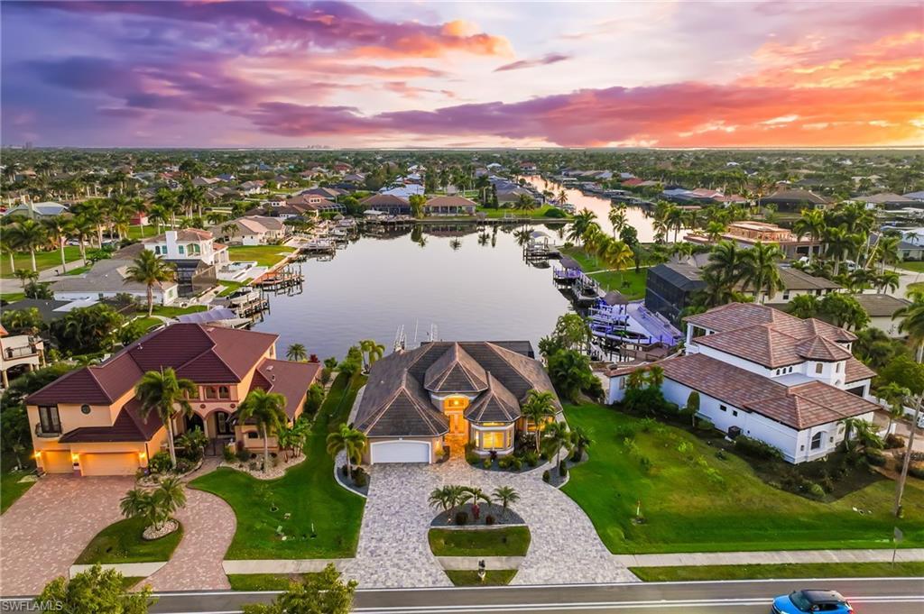 Image 4: Aerial view at dusk of a water view and a residential view
