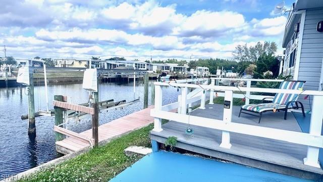 Image 4: Trek decking at waterfront ; Dock area with boat lift, a water view