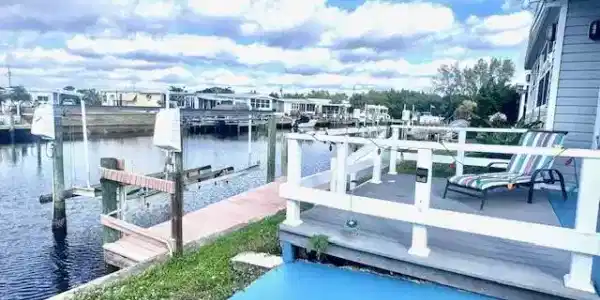 Image 4: Trek decking at waterfront ; Dock area with boat lift, a water view