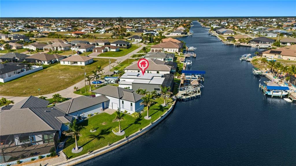 Image 2: Aerial view of residential area with a large body of water