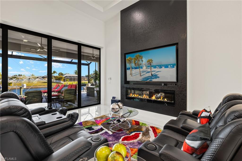 Image 4: Living room featuring a glass covered fireplace