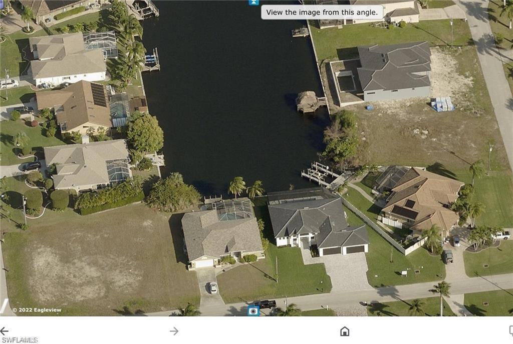 Image 2: Aerial overview of property's location featuring nearby suburban area and a nearby body of water