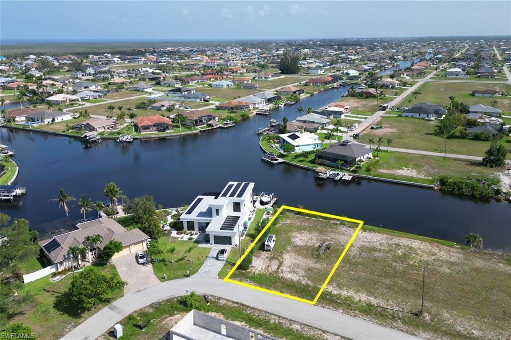 Image 3: Aerial perspective of suburban area with property boundaries highlighted and a large body of water