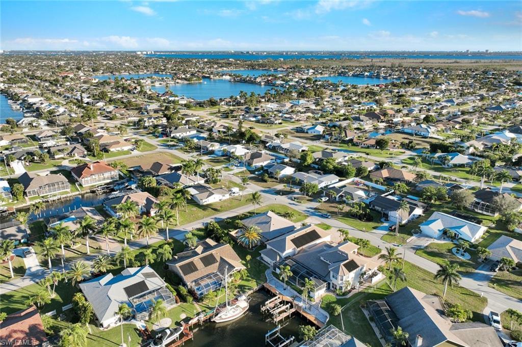 Image 2: View of property location featuring a nearby body of water and nearby suburban area