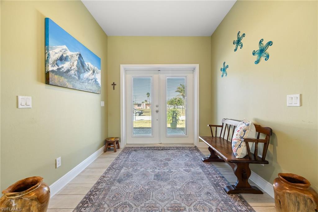 Image 3: Doorway to outside featuring wood finished floors and french doors