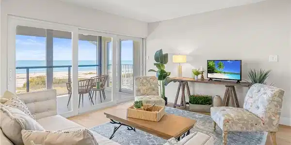 Image 4: Living room featuring light wood finished floors and a beach view