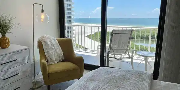 Image 4: Carpeted bedroom with a water view, access to exterior, and multiple windows