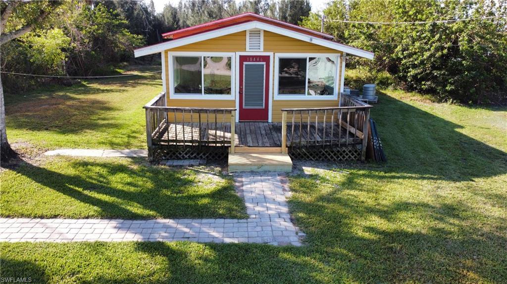 Image 1: View of front of home featuring a front lawn and an outdoor structure