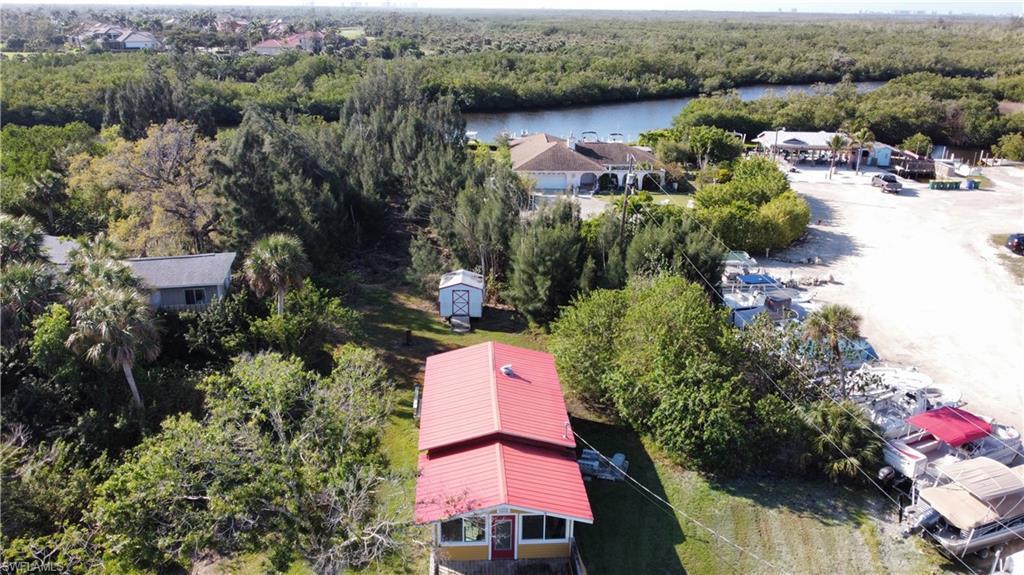 Image 2: Drone / aerial view with a water view and a wooded view