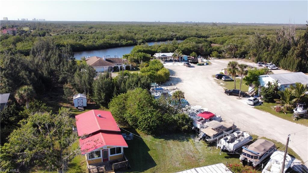 Image 4: Drone / aerial view featuring a water view and a wooded view