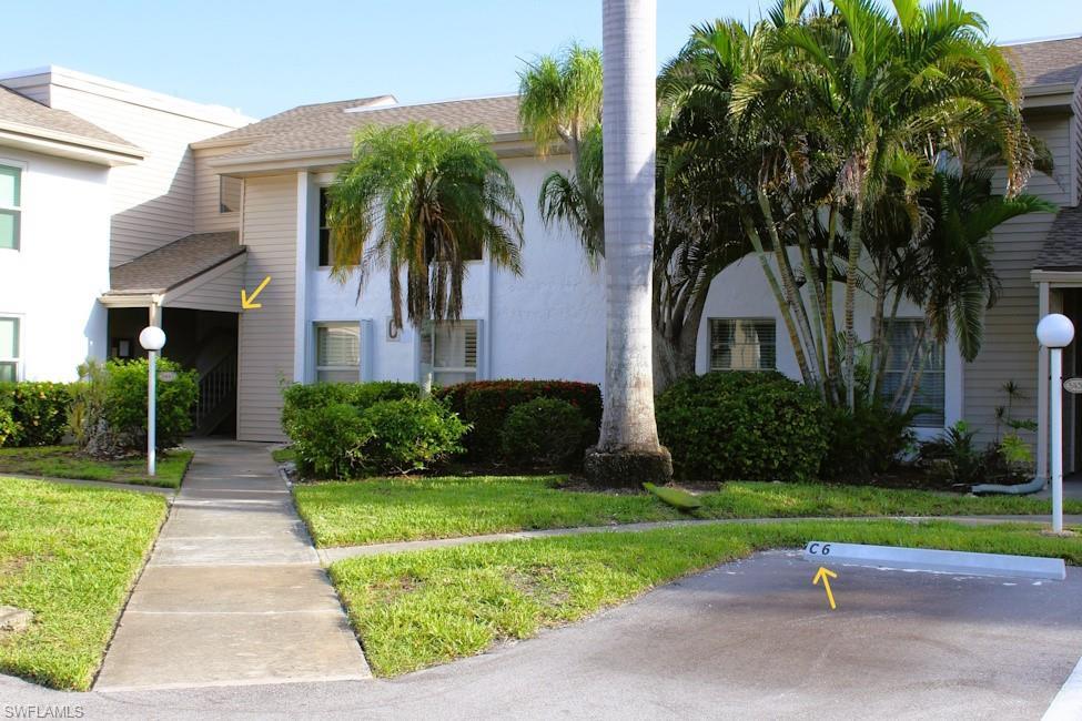 Image 2: View of front of house featuring stucco siding, uncovered parking, and a front yard