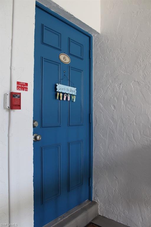Image 4: Entrance to property featuring stucco siding