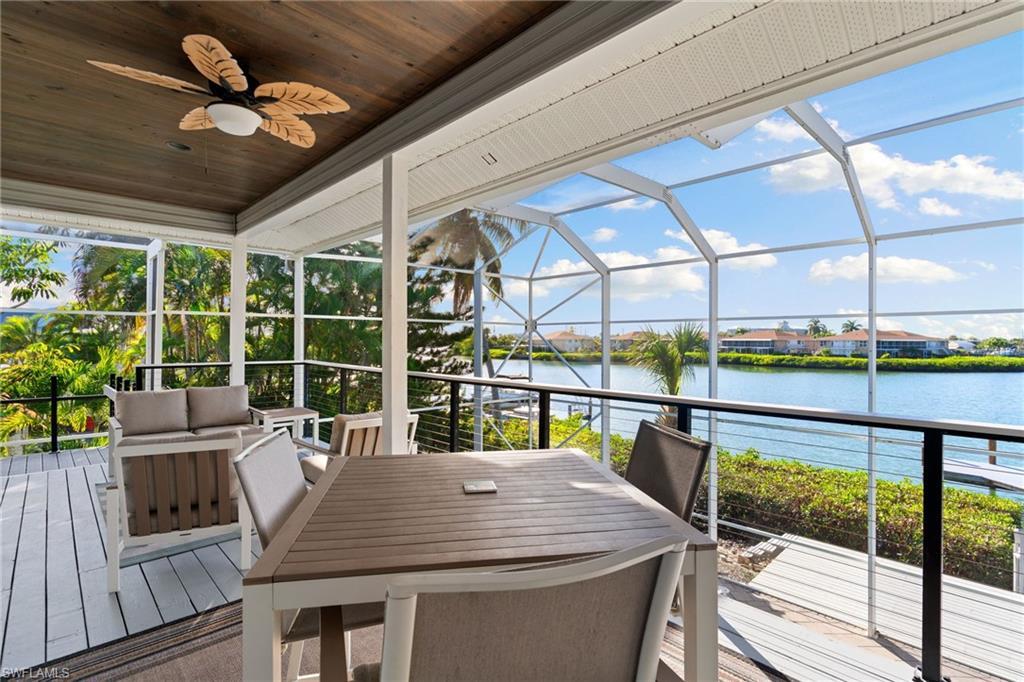 Image 4: Elevated Sun deck with a water view, a ceiling fan, and healthy amount of natural light. POOL ACCESS!