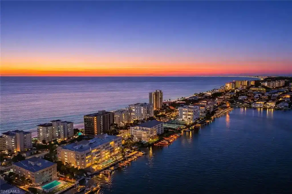 Image 1: Aerial view at dusk of a water view and a city view