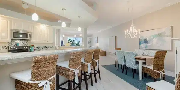 Image 3: Kitchen featuring tasteful backsplash, appliances with stainless steel finishes, hanging light fixtures, a kitchen breakfast bar, and a chandelier