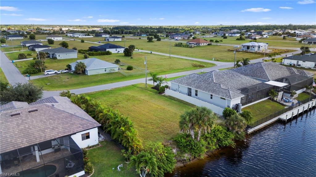 Image 2: Aerial view of residential area with a nearby body of water