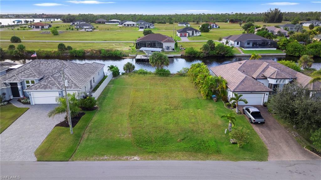 Image 4: Aerial perspective of suburban area featuring a large body of water