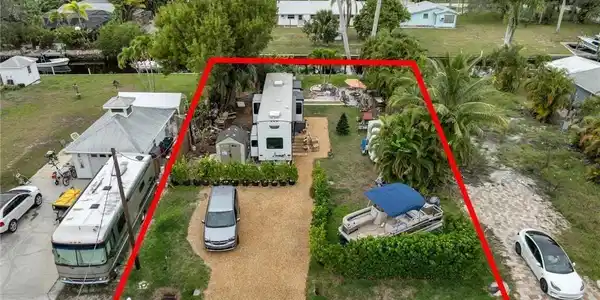 Image 3: Aerial view of property and surrounding area featuring property boundaries highlighted