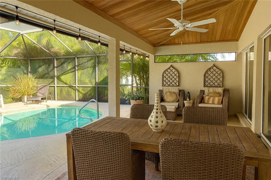 Image 2: Swimming pool featuring a lanai and outdoor dining space