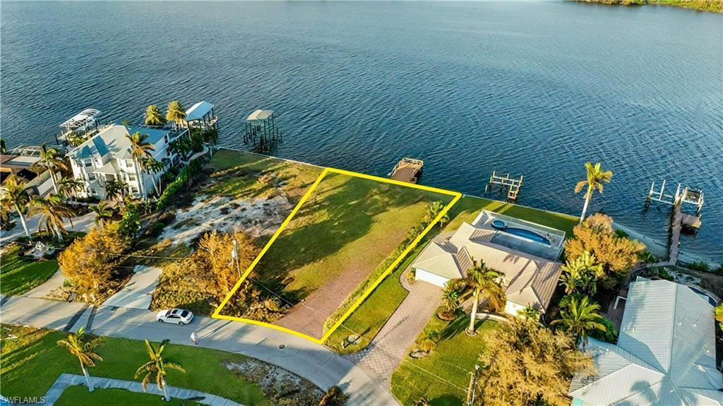 Image 2: Prime waterfront lot offering an exceptional opportunity to build your dream home with direct water access - Virtually Edited Image
