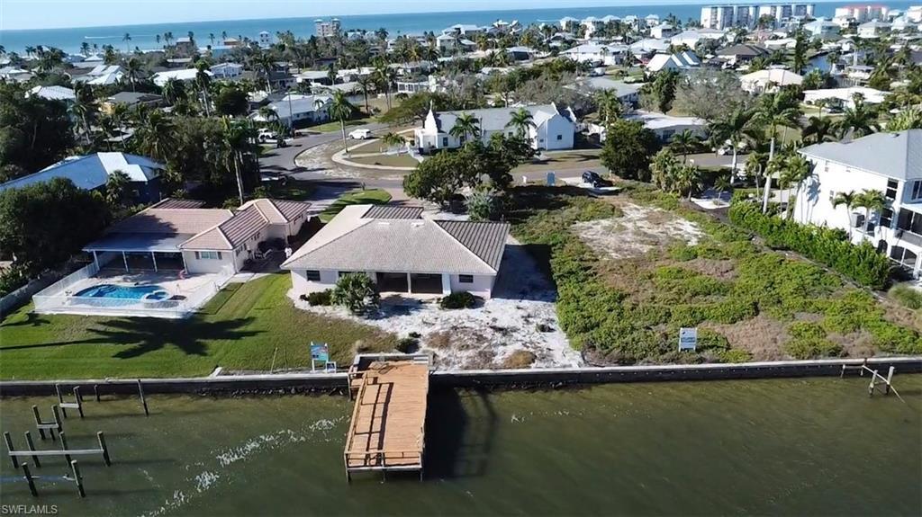 Image 4: Aerial view of residential area with a nearby body of water