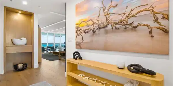 Image 2: Private elevator access opens directly into the foyer, creating a refined arrival experience with gallery art, designer built in, and an immediate sense of privacy and exclusivity