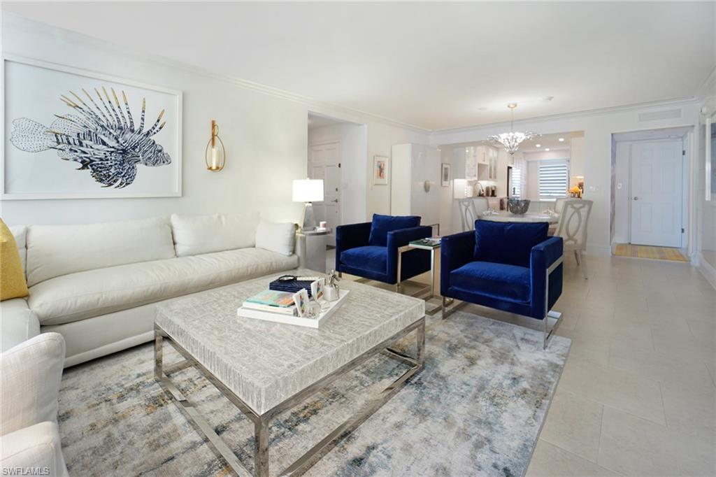 Image 4: Living area featuring ornamental molding and a chandelier