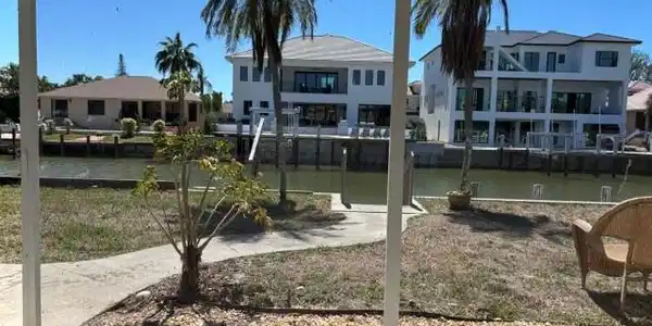 Image 2: View of yard featuring a residential view and a water view