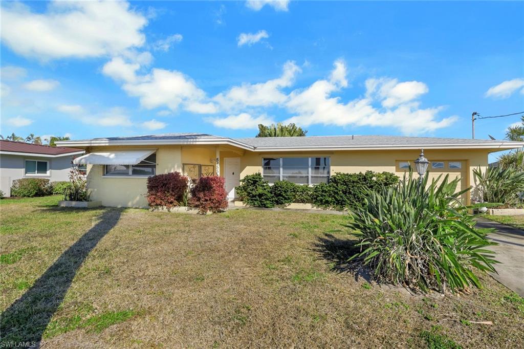Image 2: Single story home featuring stucco siding and a front yard