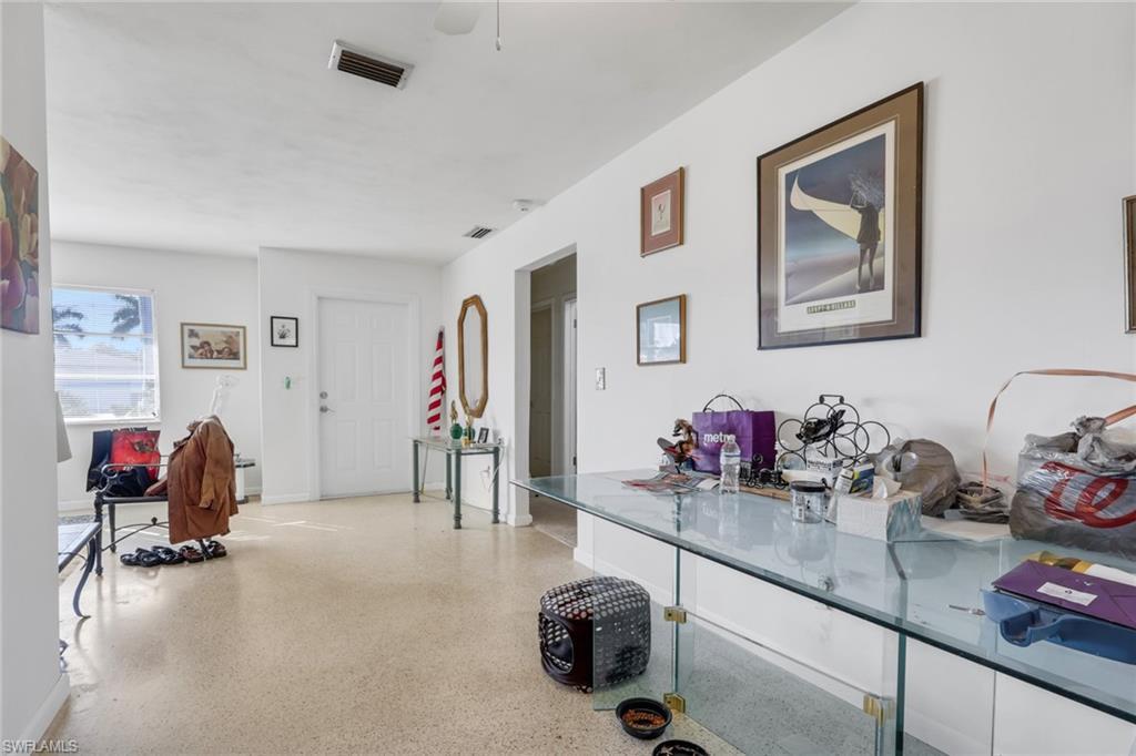 Image 4: Hallway with dark aggregate flooring and baseboards