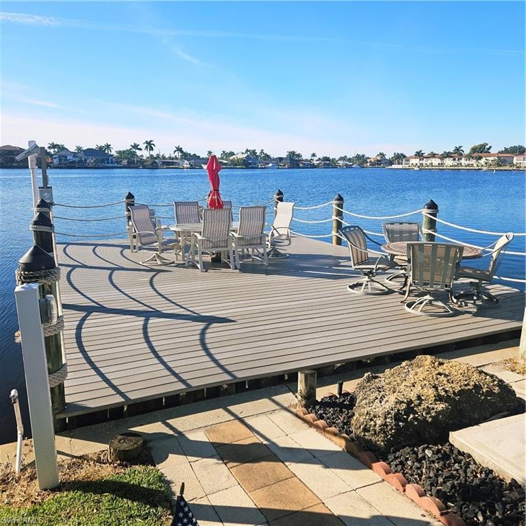 Image 4: Dock featuring a deck with water view