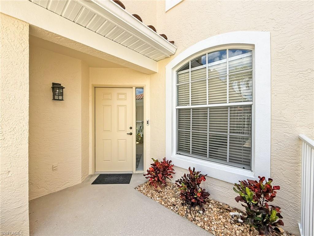 Image 3: Property entrance with stucco siding