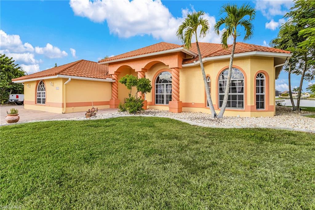 Image 2: Mediterranean / spanish home featuring stucco siding, a front yard, and a tile roof