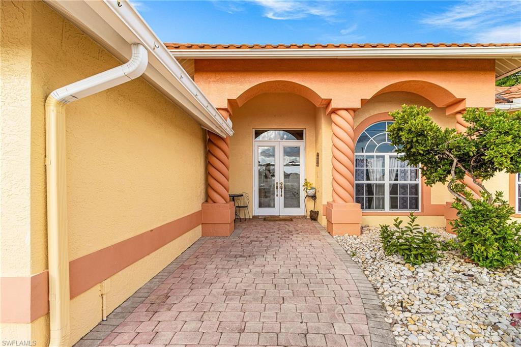 Image 4: Property entrance featuring stucco siding and french doors