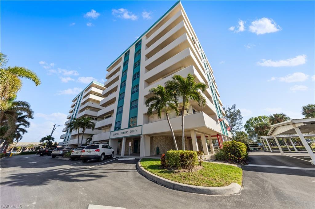 Image 1: View of apartment building / complex featuring uncovered parking