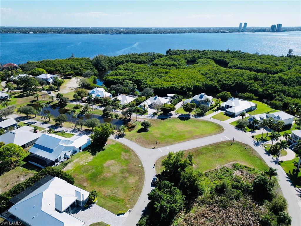 Image 2: Aerial perspective of suburban area with a large body of water