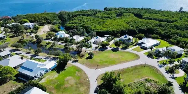 Image 2: Aerial perspective of suburban area with a large body of water