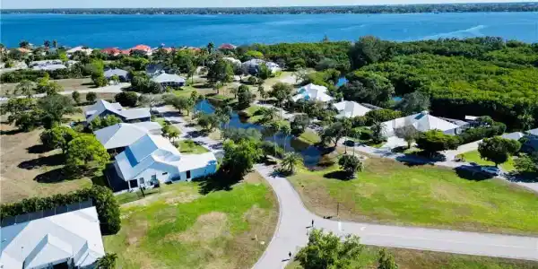 Image 4: Aerial perspective of suburban area featuring a large body of water