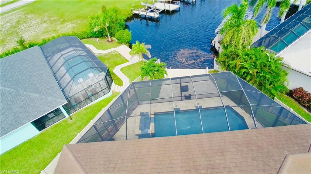 Image 2: Drone / aerial view of a nearby body of water and a pool area