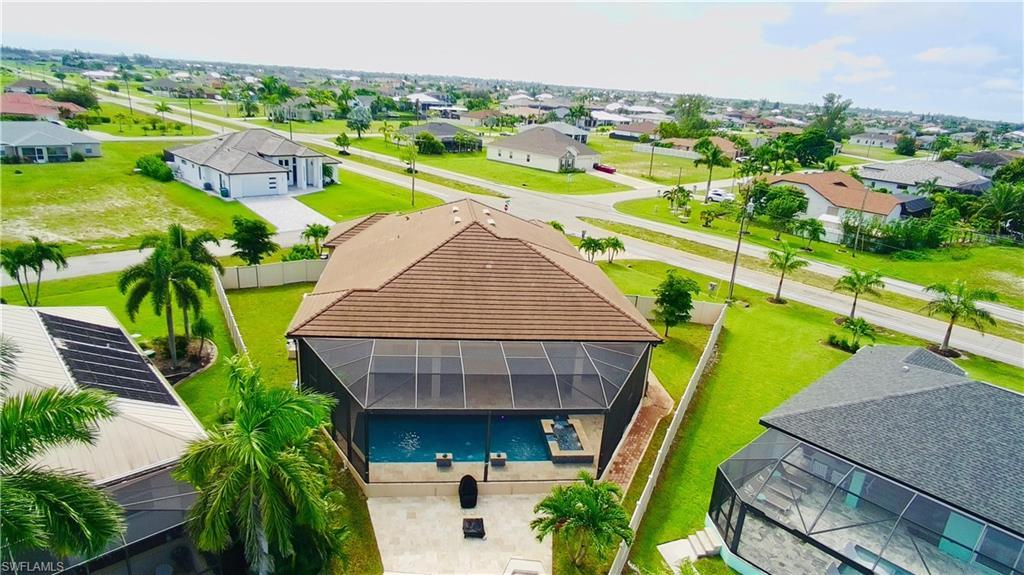 Image 3: Aerial view of residential area with a pool