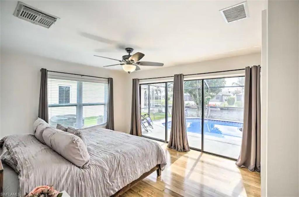 Image 2: Bedroom featuring access to exterior, light wood-type flooring, and a ceiling fan