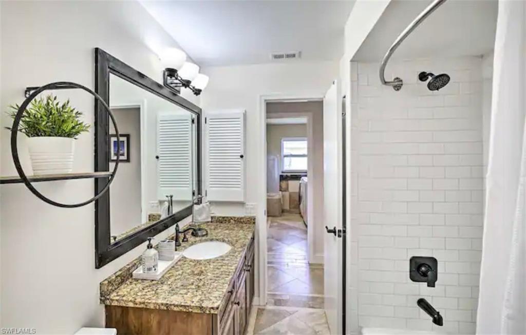 Image 3: Full bathroom with shower / tub combo with curtain and vanity