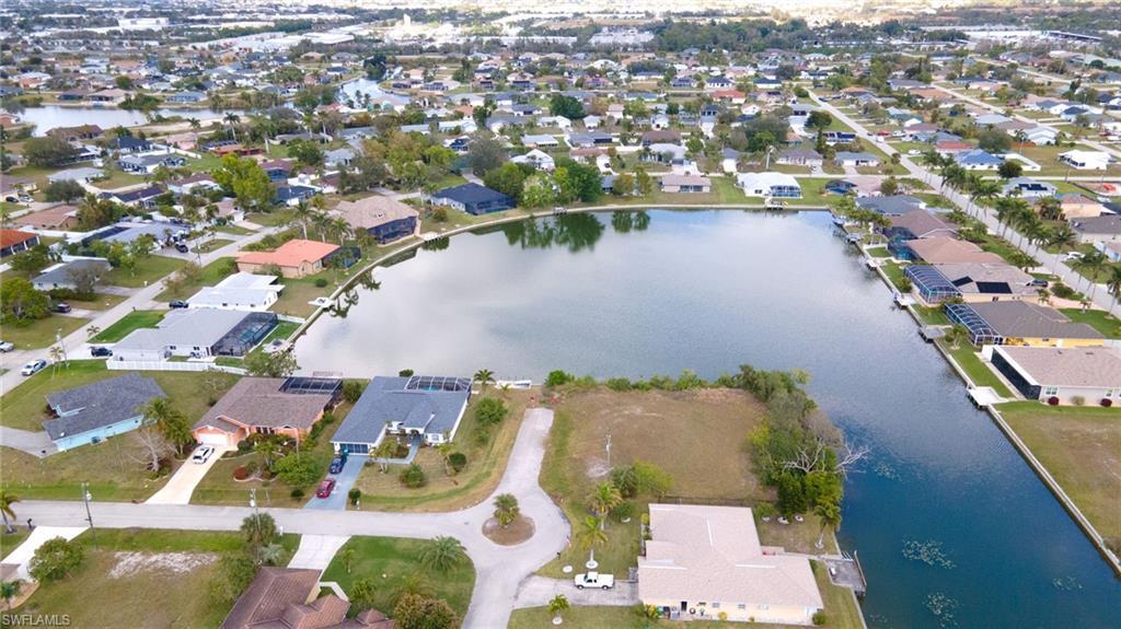 Image 3: Aerial view of property's location featuring nearby suburban area and a large body of water